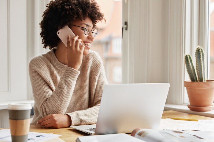 Adorable cheerful young lady working at home