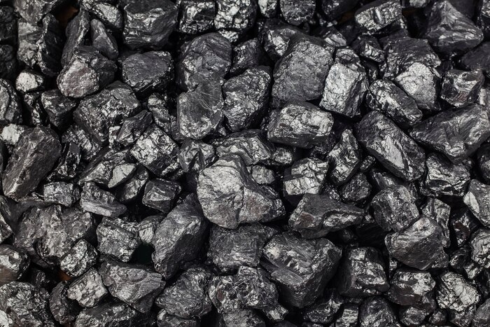 Heap of coal as background, top view