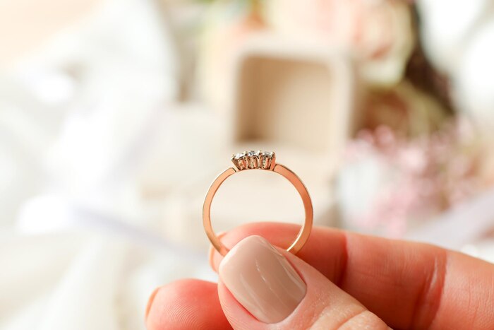 Concept of wedding accessories with wedding ring, close up